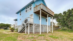 A two-story house with a balcony and a staircase leading to the second floor. - Steps to Beach: Centrally Located OBX Home! (Kill Devil Hills)