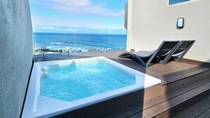 A hot tub on a wooden deck with a view of the ocean and beach amenities. - Penthouse 711 at La Montagne by First Private Stays (Ballito)