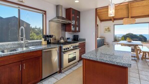 A modern kitchen with granite countertops, stainless steel appliances, and wooden cabinets. - Seabreeze Sanctuary Sea Ranch Oasis! (Sea Ranch)