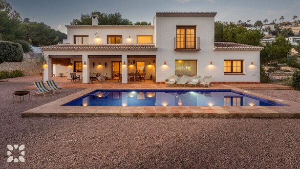 A two-story house with a swimming pool, outdoor seating, and a covered patio. - Villa HARMONIA by Abahana Villas (Teulada)