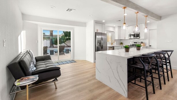 A modern kitchen with a large island, stainless steel appliances, and pendant lighting. - Scottsdale Classic - Luxury Home w/ 5 Beds & Pool! (Scottsdale)