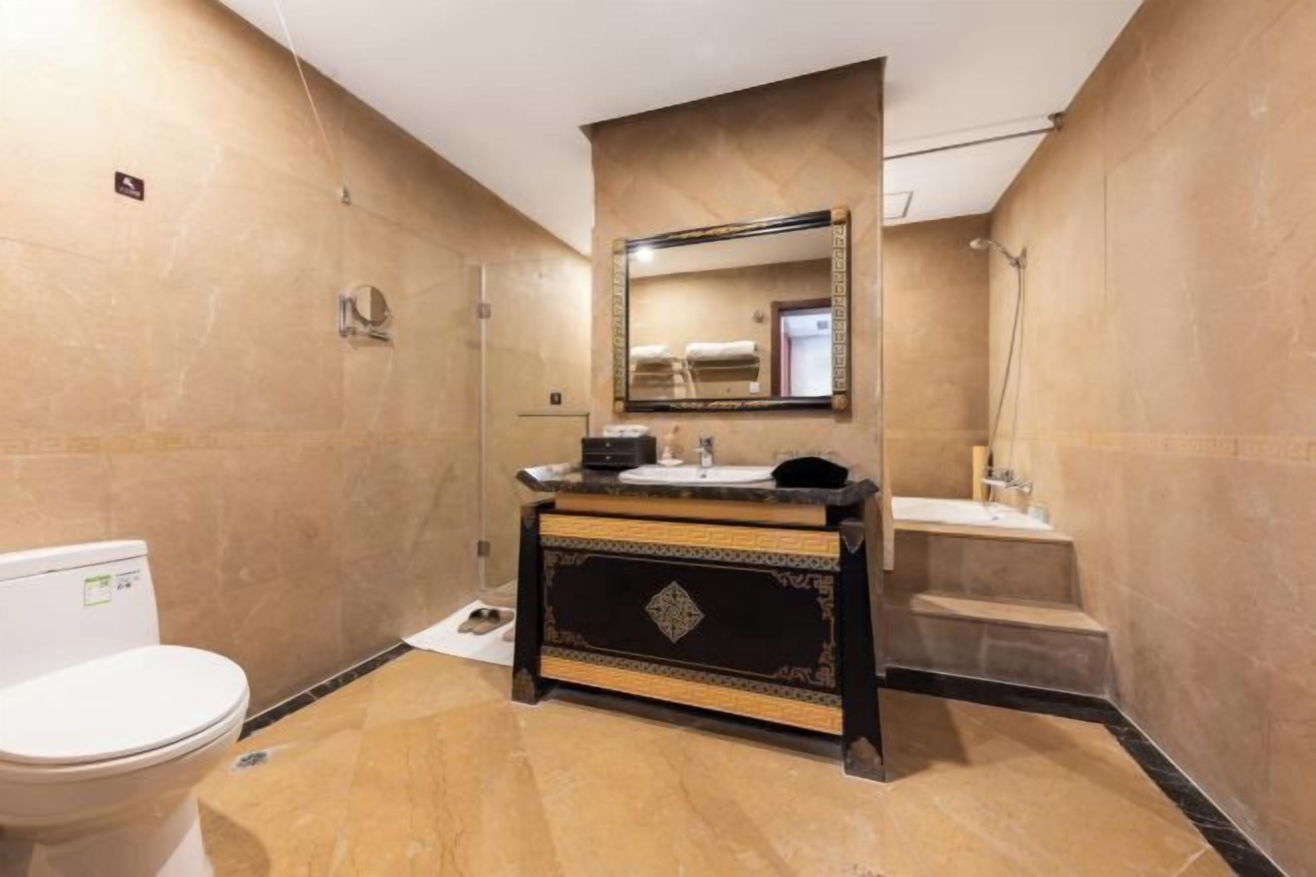 A bathroom with a toilet, sink, and shower.