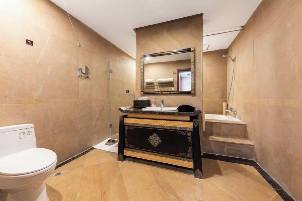 A bathroom with a toilet, sink, and shower.