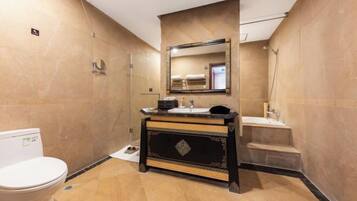 A bathroom with a toilet, sink, and shower.