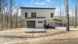 A modern two-story house with a covered patio, a garage, and a number 34 sign.