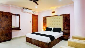A modern bedroom with a large bed, a ceiling fan, and a built-in wardrobe.