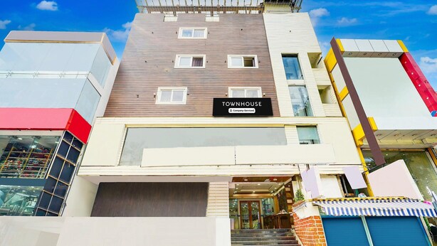 A multi-story building with a sign reading "TOWNHOUSE Company-Serviced." - Stylish Stays at MG Road Near Commercial Street (Bengaluru)
