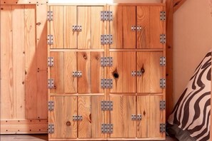 A wooden cabinet with multiple compartments, each secured with metal brackets.