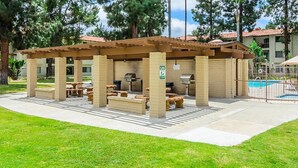 A covered outdoor seating area with picnic tables and barbecue grills. - 2-Bedroom Condo - close to all! (San Diego)