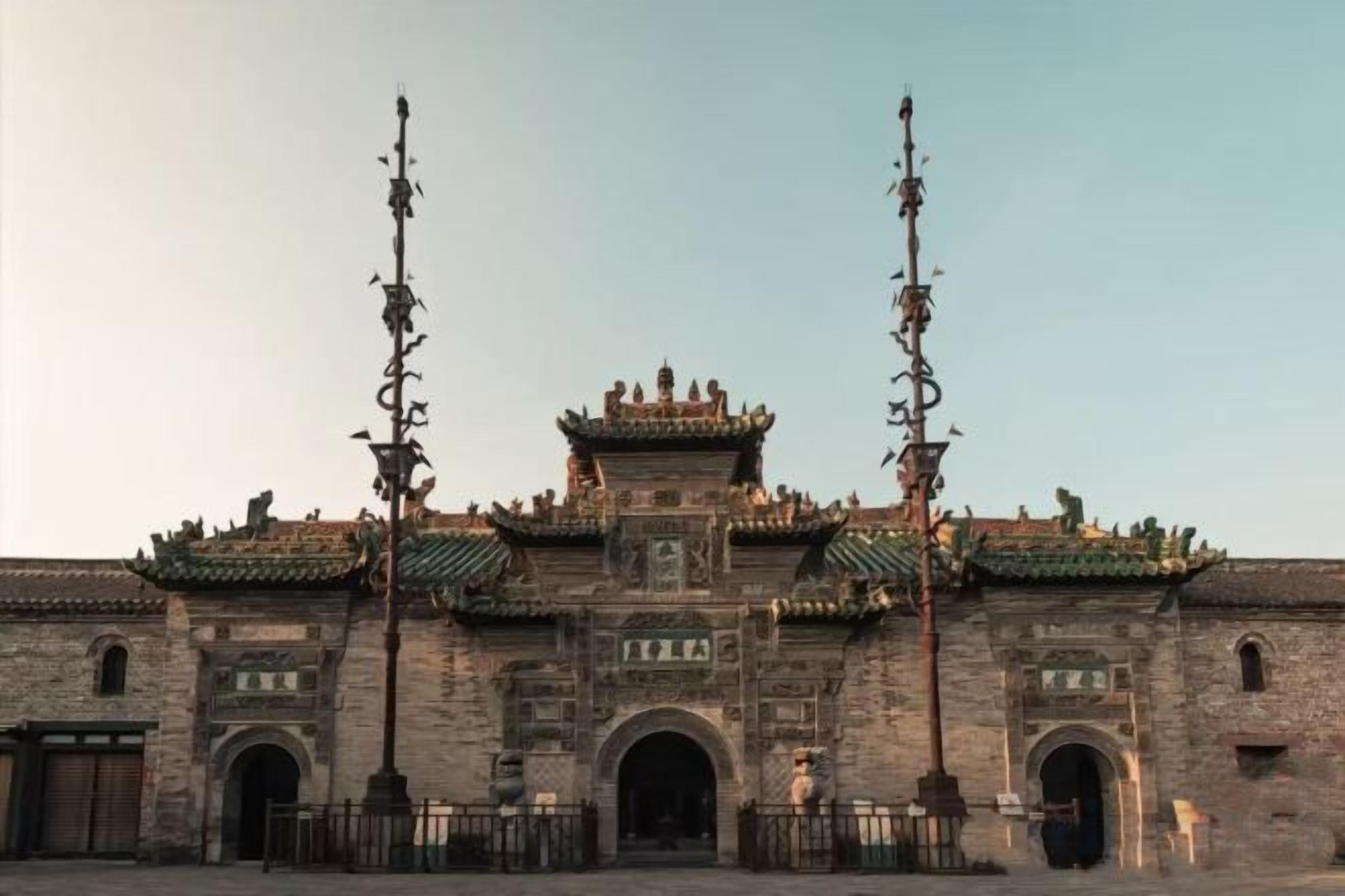 A traditional building with a symmetrical facade, multiple arches, and a central elevated section with intricate detailing.