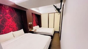 A hotel room with two beds, a nightstand, a red patterned wall, and a ceiling light. - Ching Shang Tien Hua (New Taipei City)