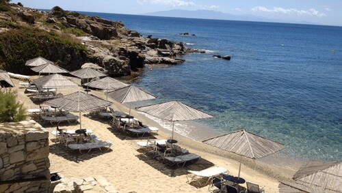 Cozy Mykonian condo in a resort with pool and beach.