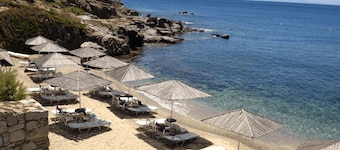 Cozy Mykonian condo in a resort with pool and beach.