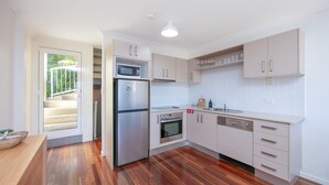 A modern kitchen with a refrigerator, oven, microwave, and sink. - Seaspray 6 - Short walk to the beach and Yamba's CBD (Yamba)