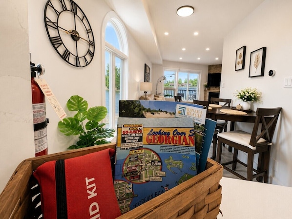 A kitchen with a wooden table, a clock, and a map of Georgia.