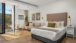 A modern bedroom with a large bed, a sofa, a small table with flowers, and a view of the city through large windows.