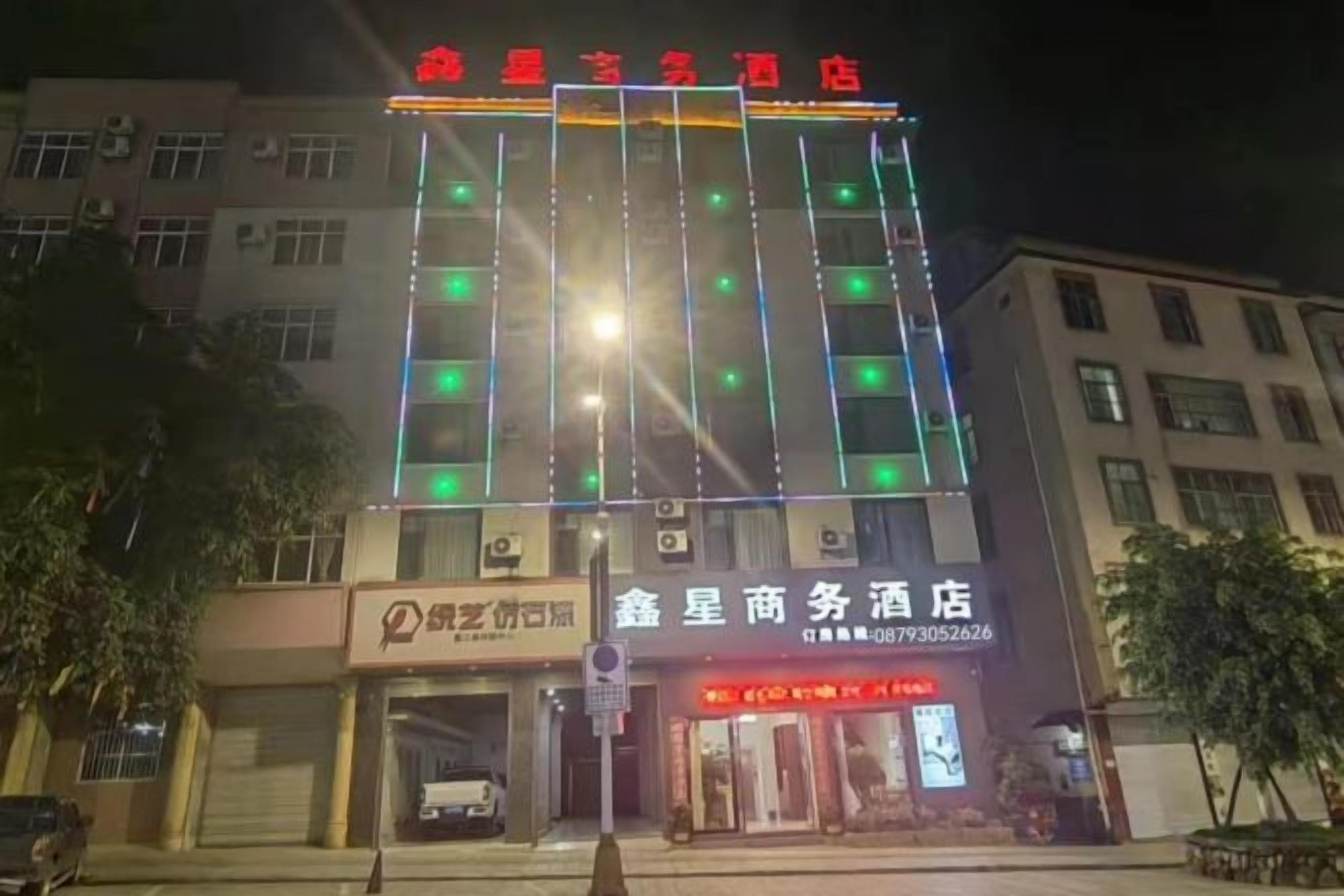 A building with multiple floors and illuminated signage.