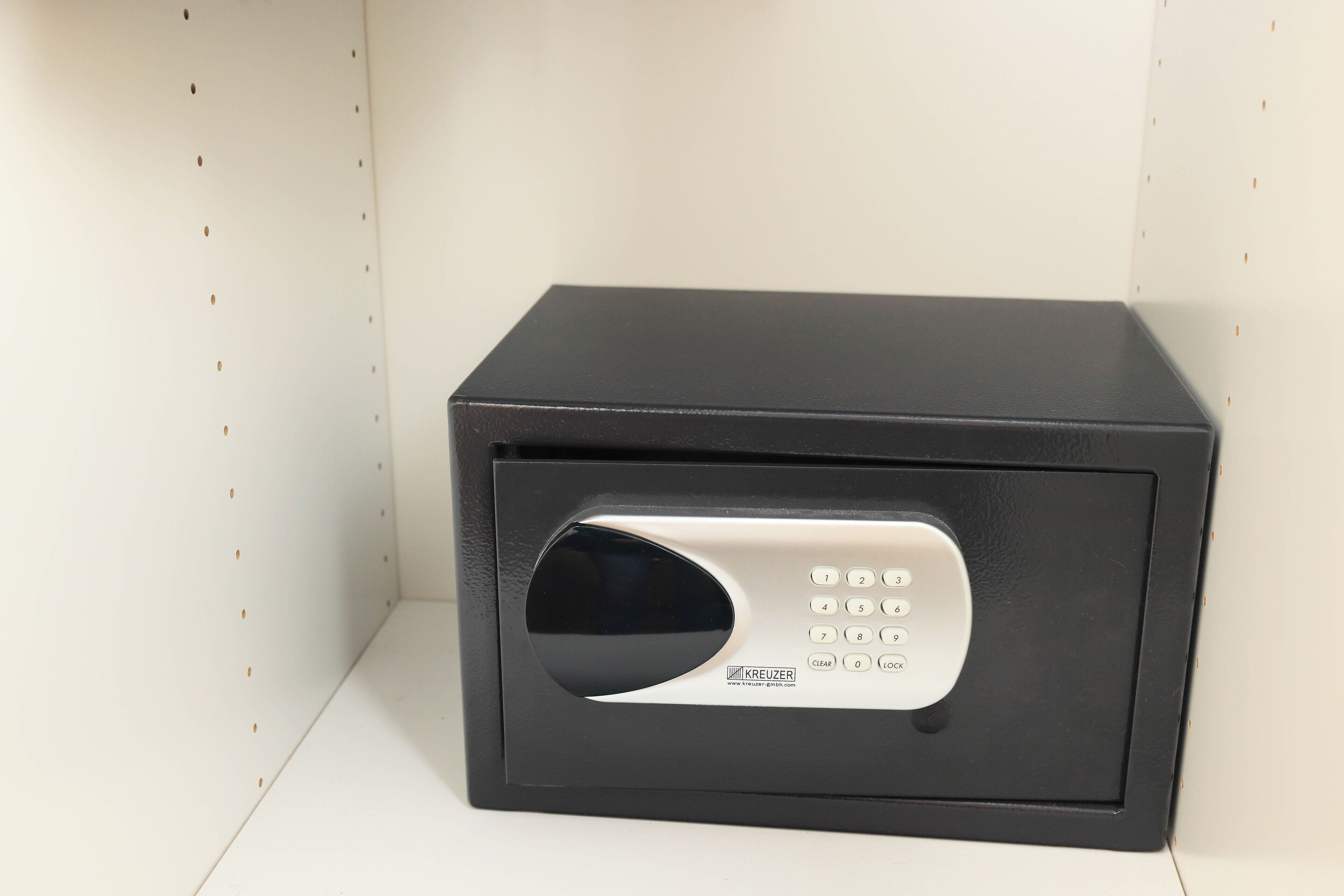 A black safe with a keypad and a clear button.