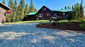 A lodge with a gravel driveway, surrounded by trees. - Kenai Riverfront Cabin! Fish, Explore, & Relax! (Sterling)
