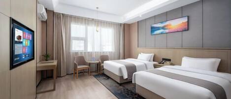 A hotel room with two beds, a desk, a chair, a TV, and a large window with curtains.