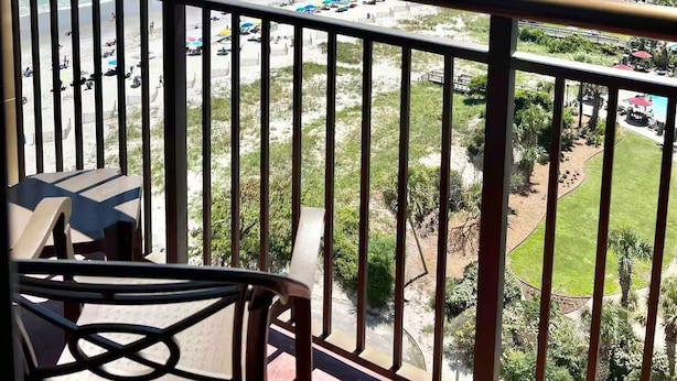 A balcony with a view of a beach and ocean. - Oceanfront Double-Room; Oceanview, Privacy & Space (Myrtle Beach)