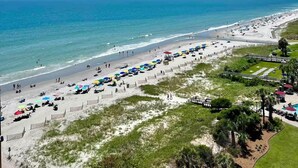 A beach with umbrellas and sun loungers, a clear sky, and the ocean. - Oceanfront Double-Room; Oceanview, Privacy & Space (Myrtle Beach)