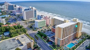 A coastal hotel with multiple buildings, a swimming pool, and a beach view. - Oceanfront Double-Room; Oceanview, Privacy & Space (Myrtle Beach)
