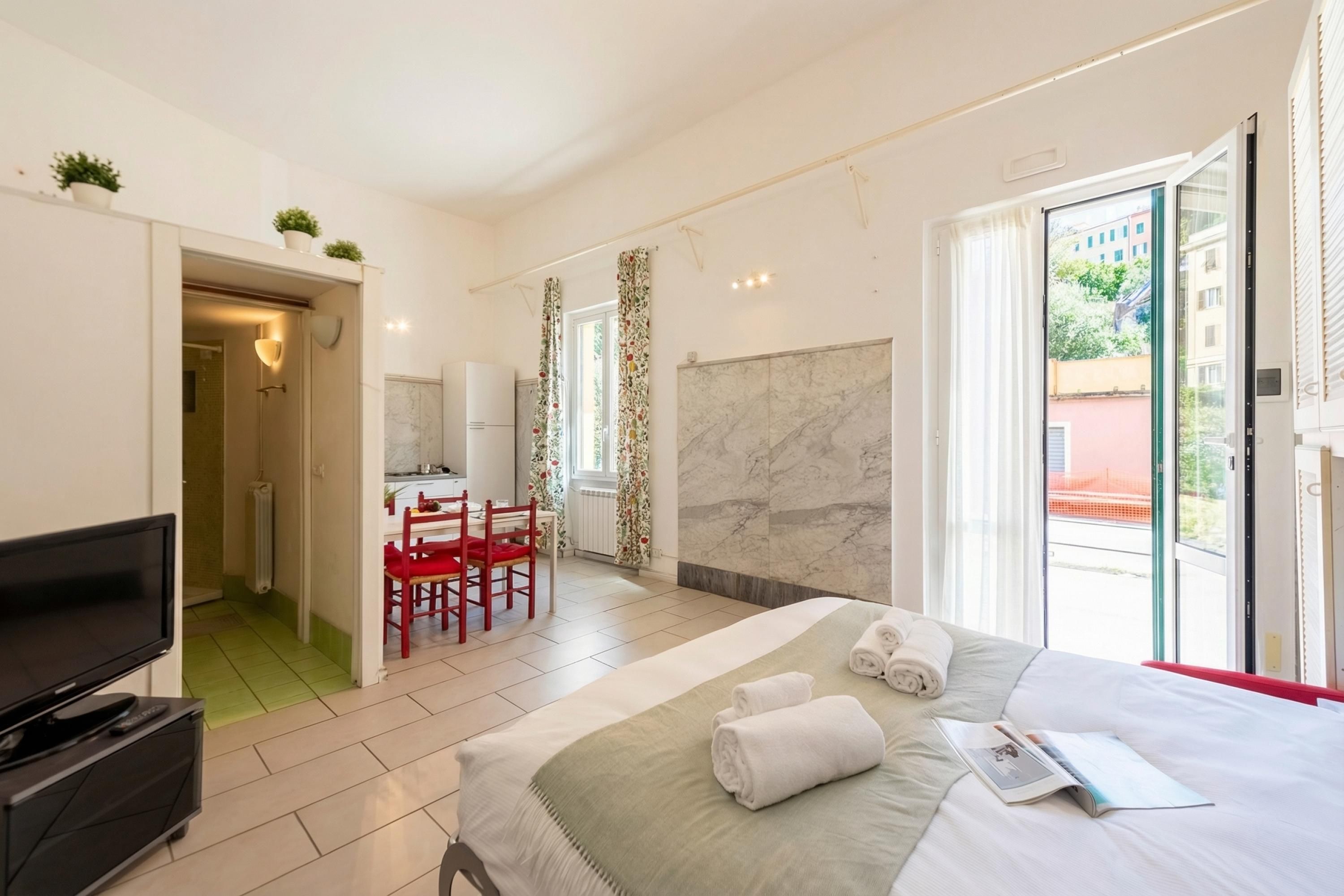 Une chambre d’hôtel comprenant un lit, une télévision, un coin repas et une salle de bain.