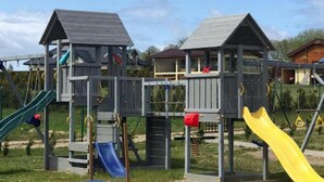 A playground with multiple slides and climbing structures. - Holiday Home in Mielenko Near Seaside Beach (Mielno)