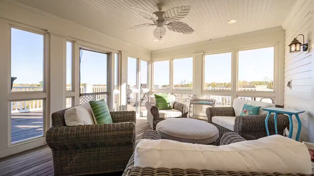 A sunlit room with wicker furniture, large windows, and a ceiling fan. - A Country Retreat at Airy Knob Farm (Greencastle)