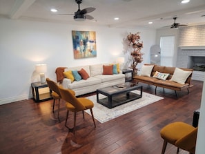 A living room with a sofa, armchairs, a coffee table, and a fireplace. - Pool | BBQ | Game Room | Gym | Patio | Workspace (Houston)