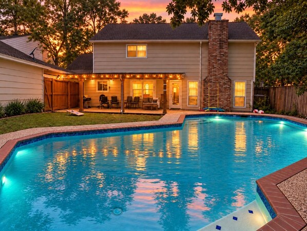 A swimming pool with a house in the background. - Pool | BBQ | Game Room | Gym | Patio | Workspace (Houston)