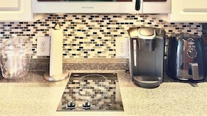 A kitchen with a stainless steel microwave, a coffee maker, and a toaster. - NEW! 2nd Floor Studio w/Kitchen (Myrtle Beach)
