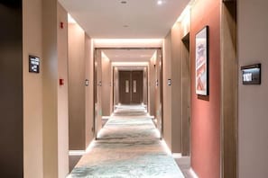 A hotel corridor with a marble floor, doors on both sides, and a sign indicating room number 1101. - Beijing Fuyou Street Hotel (Xidan Branch) (Beijing)