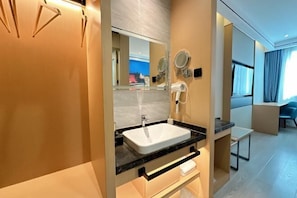 A modern bathroom with a white sink, mirrors, and a hairdryer. - Vientiane Hengyuan Hotel (Nanjing Jianning Road Railway Station) (Nanjing)
