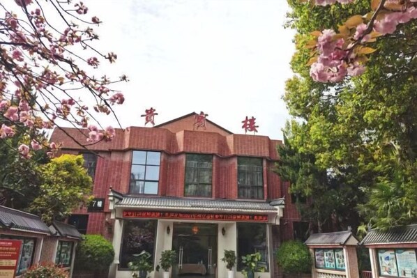 A red brick building with a traditional Chinese architectural style, featuring a tiled roof and a central entrance with a decorative archway. - Vientiane Hengyuan Hotel (Nanjing Jianning Road Railway Station) (Nanjing)