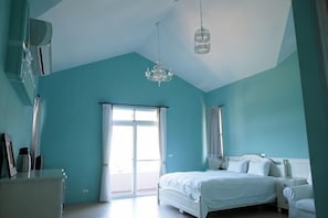 A bedroom with a bed, a dresser, a chair, a chandelier, and a large window. - Bear Meets Moose Bed and Breakfast (Nantou)