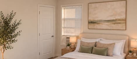 A bedroom with a bed, bedside tables, a potted plant, a window with blinds, and a painting on the wall.