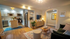 A modern apartment with a kitchen, dining area, and living room. - Prime Location on Main Street (Stroudsburg)