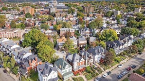 An aerial view of a residential area with a mix of houses and a prominent church steeple. - Shadyside/Pittsburgh, Modern & Unique 1 Bedroom with Free Parking (Pittsburgh)