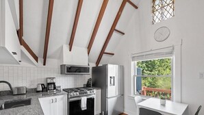 A modern kitchen with granite countertops, stainless steel appliances, and a wooden ceiling. - Shadyside/Pittsburgh, Modern & Stylish 1 Bedroom with Free Parking (Pittsburgh)