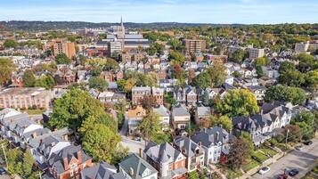 An aerial view of a residential area with houses, a church, and a large building with a spire.