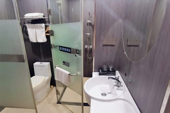 A modern bathroom with a glass-enclosed shower, a white sink, and a toilet. - Jingyi Boutique Hotel (Anqing Petrochemical No.1 Middle School) (Anqing)