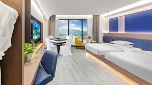 A modern hotel room with a large bed, a desk with a chair, a small table, and a TV. - Stone Hotel (Kaili Downtown Wanda Plaza) (Kaili)