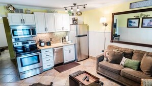 A compact living space with a kitchenette, a sofa, and a coffee table. - Gulf Shores Plantation 3305 (Gulf Shores)