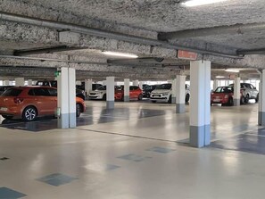 A multi-level underground parking garage with concrete pillars and a clean, reflective floor. - The best location in the city center! (Bergerac)