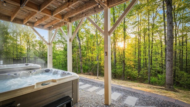 A hot tub under a wooden pergola with a forest view. - 6 King Bedrms! Heated Pool. 2 Hot Tubs. Game Room. 3 Fire Pits. Sleeps 22! (Fletcher)