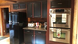 A compact kitchen with a Galanz refrigerator, a Jenn-Air oven, and a toaster. - Peaceful Couples Getaway in Lake Superior Forest (Paradise)