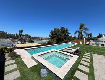 65 foot lap pool with 10 person hot tub, baja shelf, and sun loungers