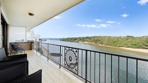 A balcony with a view of a river and forest, featuring outdoor furniture and a railing. - Creekfront Kingscliff Waters 5 (Kingscliff)